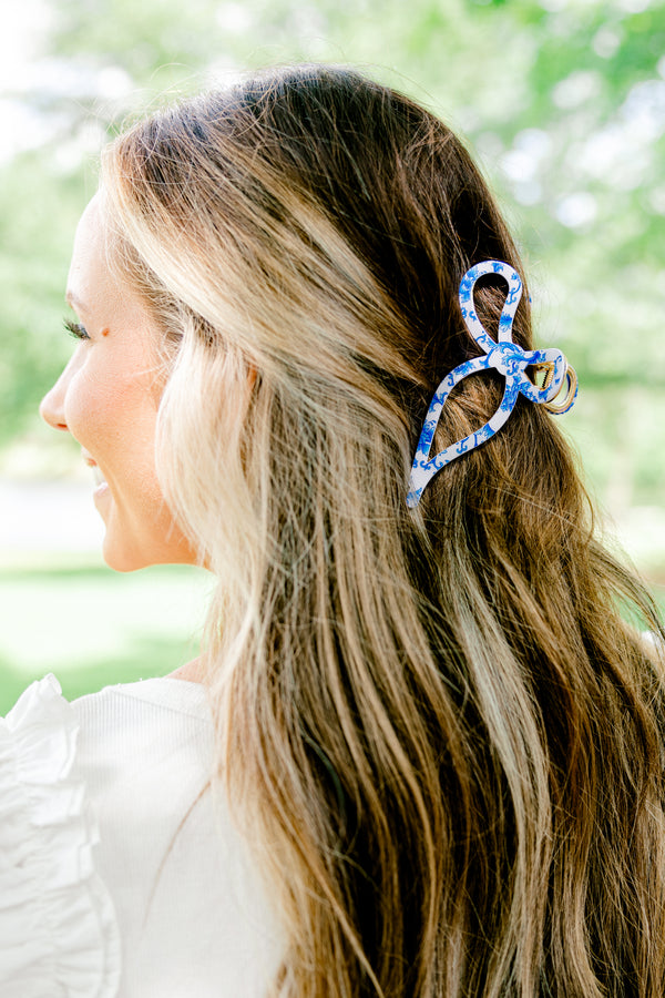 Chic Soul Plus size clothing, blue and white hair clip that is in the shape of a ribbon that has a toile print 

