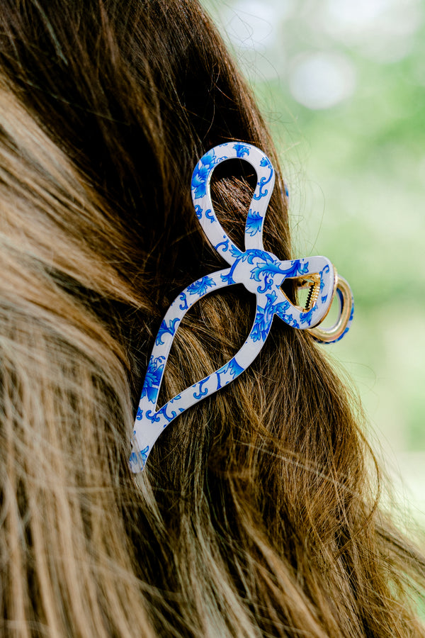 Chic Soul Plus size clothing, blue and white hair clip that is in the shape of a ribbon that has a toile print 
