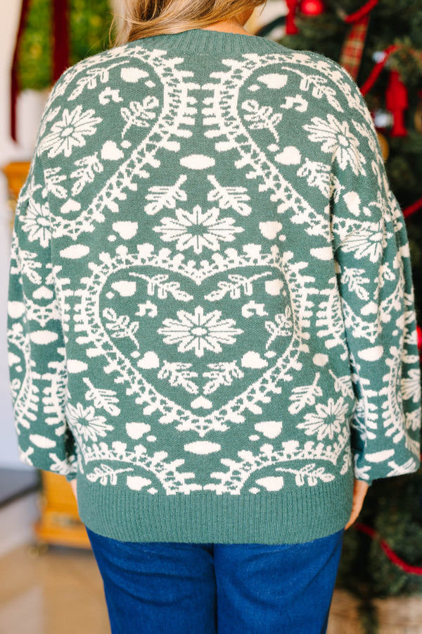 Plus size green and white fair isle heart sweater with a relaxed, flowy fit.