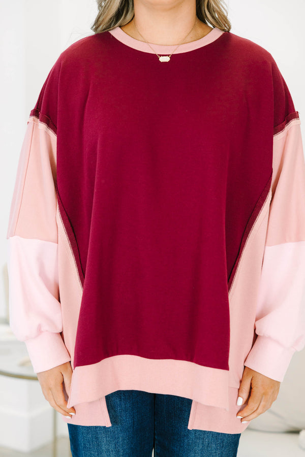 Plus Size burgundy and pink colorblock pullover with a crew neck and long sleeves.