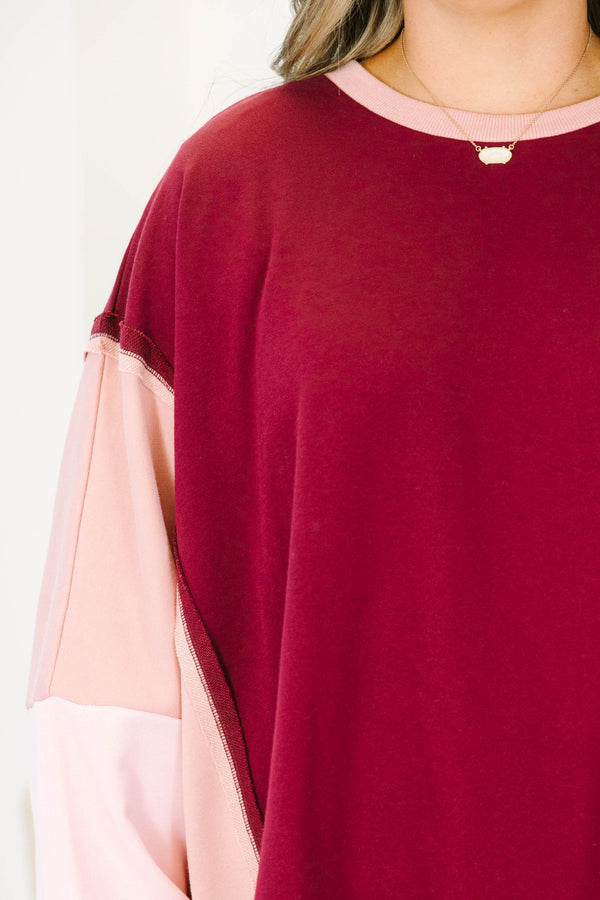 Plus Size burgundy and pink colorblock pullover with a crew neck and long sleeves.