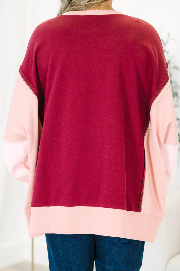 Plus Size burgundy and pink colorblock pullover with a crew neck and long sleeves.