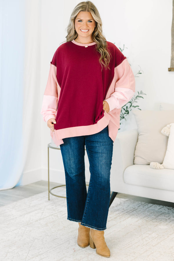 Plus Size burgundy and pink colorblock pullover with a crew neck and long sleeves.