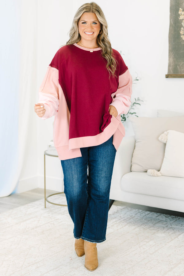 Plus Size burgundy and pink colorblock pullover with a crew neck and long sleeves.