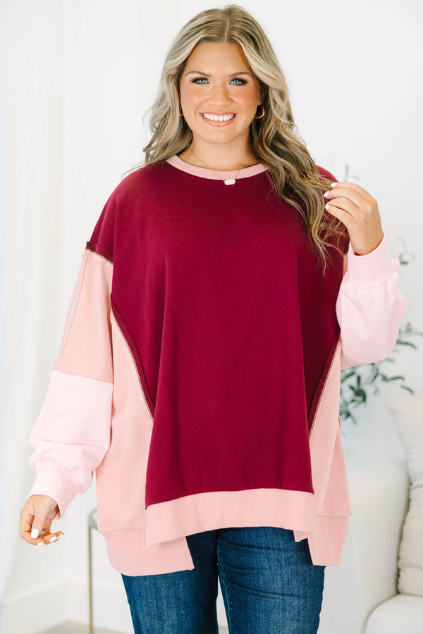 Plus Size burgundy and pink colorblock pullover with a crew neck and long sleeves.