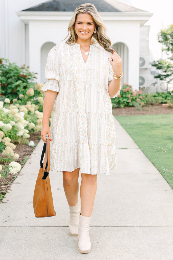 Plus Size cream tiered mini dress with a floral stripe pattern, V-neckline, and puff sleeves.