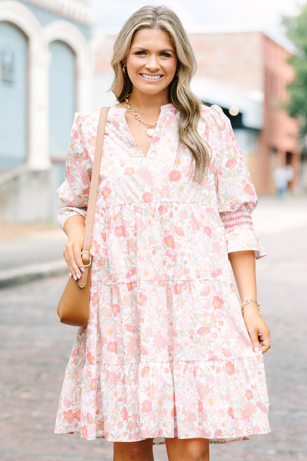 Plus Size pink floral mini dress with a split v-neck, tiered skirt, and smocked bell sleeves.