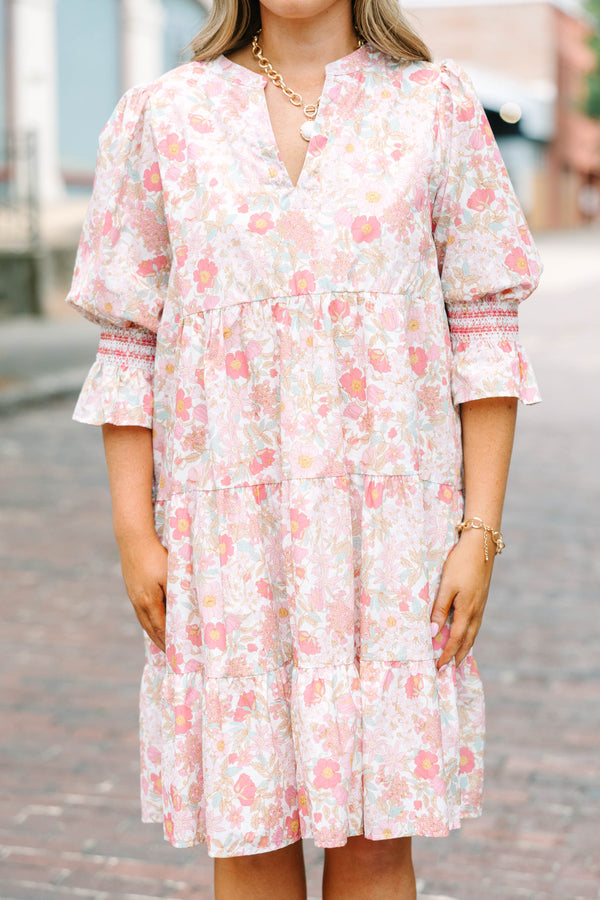 Plus Size pink floral mini dress with a split v-neck, tiered skirt, and smocked bell sleeves.