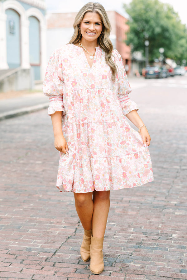 Plus Size pink floral mini dress with a split v-neck, tiered skirt, and smocked bell sleeves.