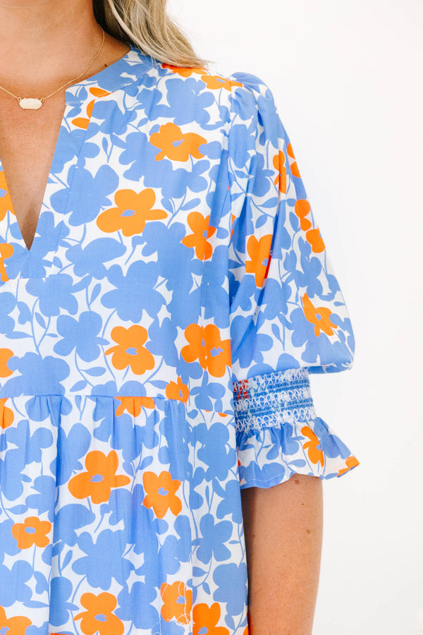 Plus Size tiered mini dress in a blue and orange floral print with a V-neckline and short sleeves.