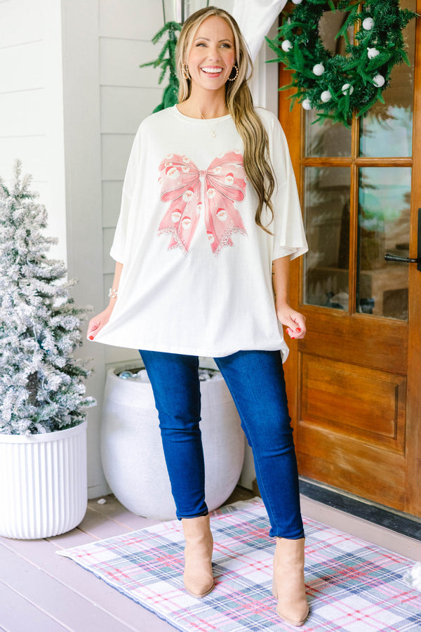 Chic Soul plus size clothing, ivory oversized boyfriend tee with large red Santa print bow in the middle