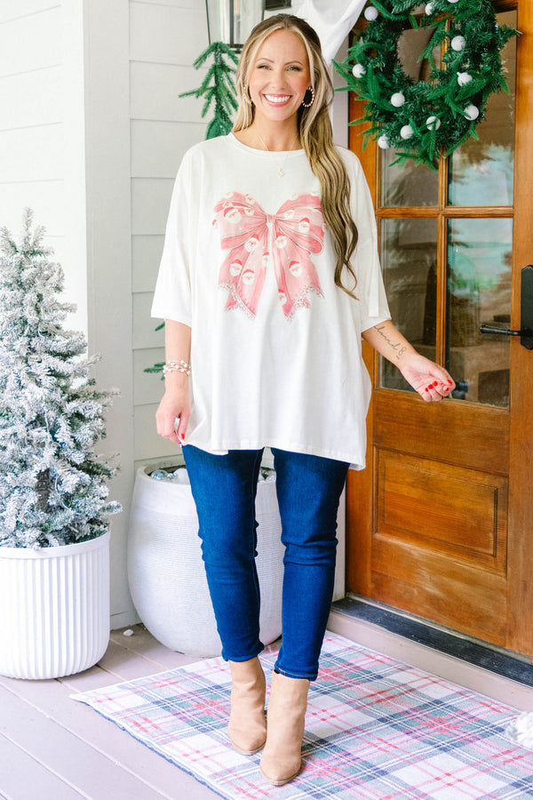 Chic Soul plus size clothing, ivory oversized boyfriend tee with large red Santa print bow in the middle