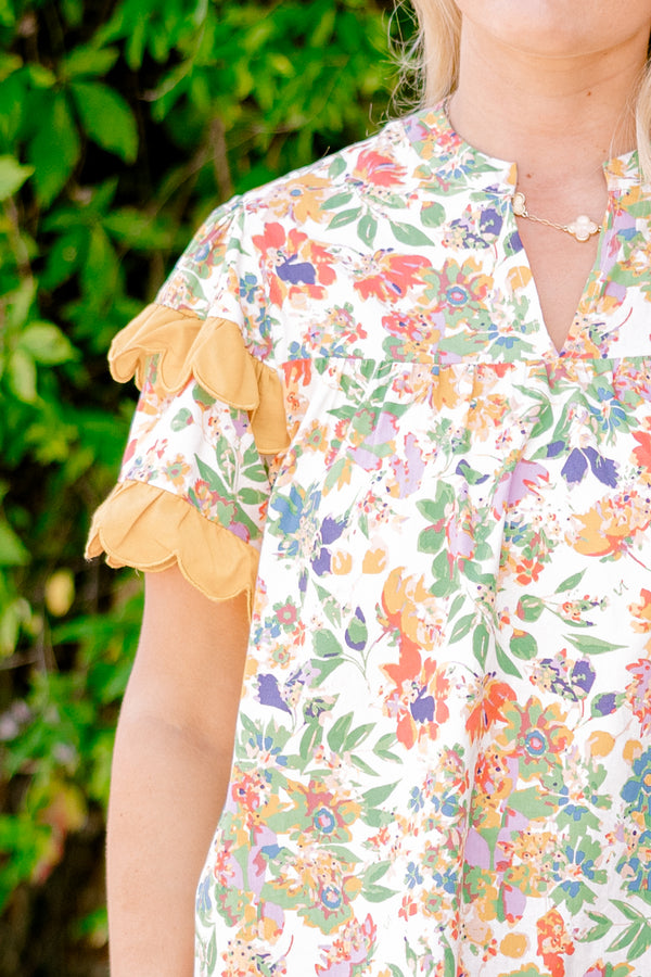 Chic Soul plus size clothing, white and multi colored floral print short sleeve top with orange scallop trim on sleeves