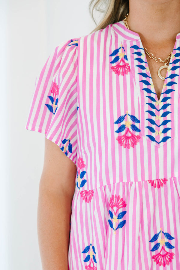 Plus size pink striped midi dress with floral embroidery, flowy fit, and short flutter sleeves.