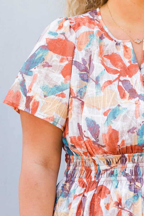 Chic Soul plus size clothing, short-sleeve rust maxi dress with smocked waistline and v-neckline with ruffled detailing and purple multi-colored watercolor floral pattern
