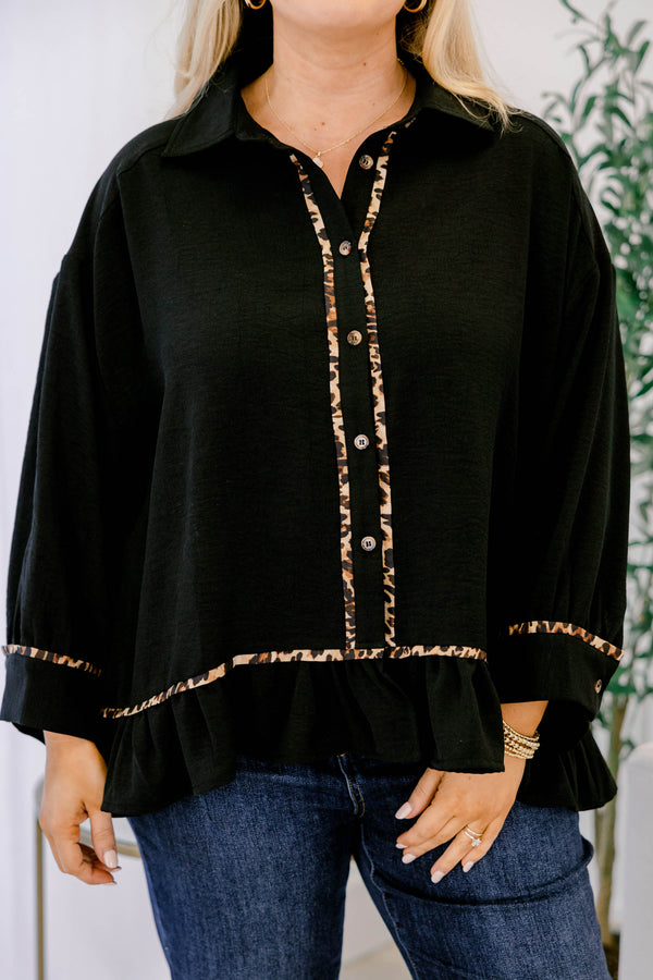 Chic Soul plus size clothing, black long sleeve top with a flare at the bottom as well as leopard stitching details at the bottom of each sleeve going down the center of the shirt and on the bottom of the shirt 