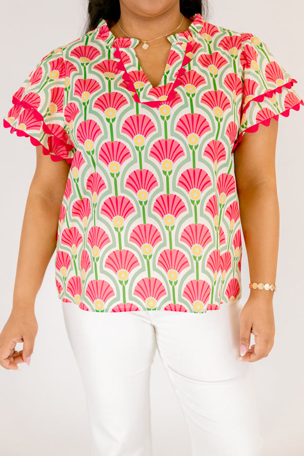 Chic Soul plus size clothing, pink top with flutter sleeves that have a pink scalloped detail outlining the ends of each ruffle as well as going along the v-neckline and a floral block pattern throughout 