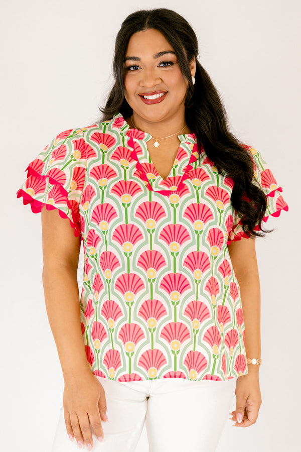 Chic Soul plus size clothing, pink top with flutter sleeves that have a pink scalloped detail outlining the ends of each ruffle as well as going along the v-neckline and a floral block pattern throughout 