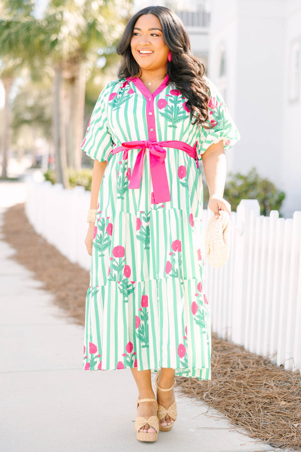 Chic Soul plus size clothing, green striped tiered maxi dress with a pink strip outlining the v-neckline and going down to the bottom of the buttons on the chest as well as a pink belt that ties around the waist and floral block pattern throughout