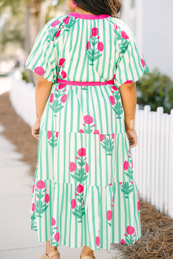Chic Soul plus size clothing, green striped tiered maxi dress with a pink strip outlining the v-neckline and going down to the bottom of the buttons on the chest as well as a pink belt that ties around the waist and floral block pattern throughout