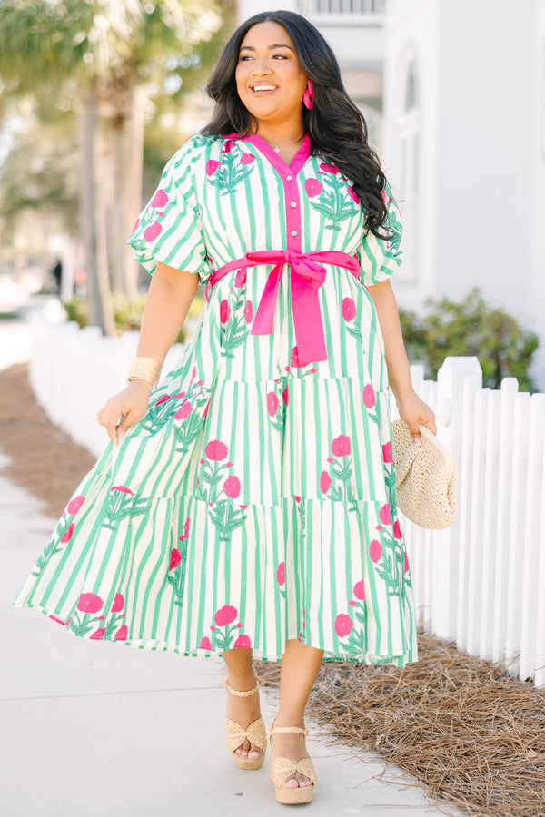 Chic Soul plus size clothing, green striped tiered maxi dress with a pink strip outlining the v-neckline and going down to the bottom of the buttons on the chest as well as a pink belt that ties around the waist and floral block pattern throughout