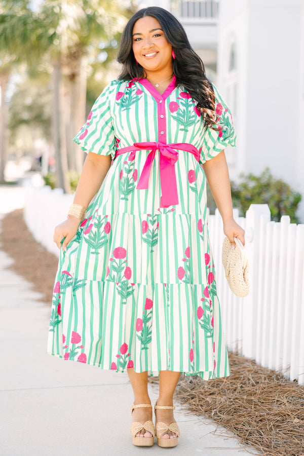 Chic Soul plus size clothing, green striped tiered maxi dress with a pink strip outlining the v-neckline and going down to the bottom of the buttons on the chest as well as a pink belt that ties around the waist and floral block pattern throughout