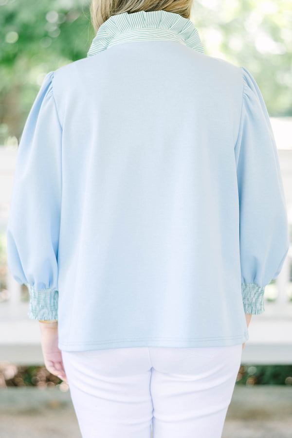 Plus size top in light blue with striped ruffle collar and smocked cuffs.