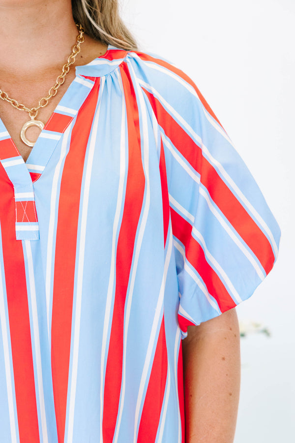 Plus size blue and red vertical striped shift dress with puff sleeves and a v-neckline.