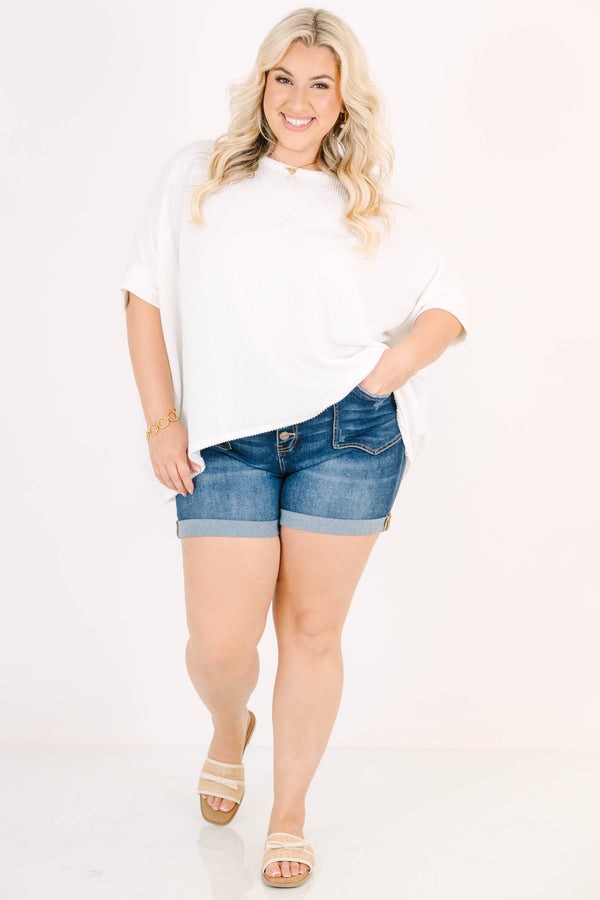 Plus Size dark wash denim shorts with a button-up fly, cuffed hems, and front seam detailing.
