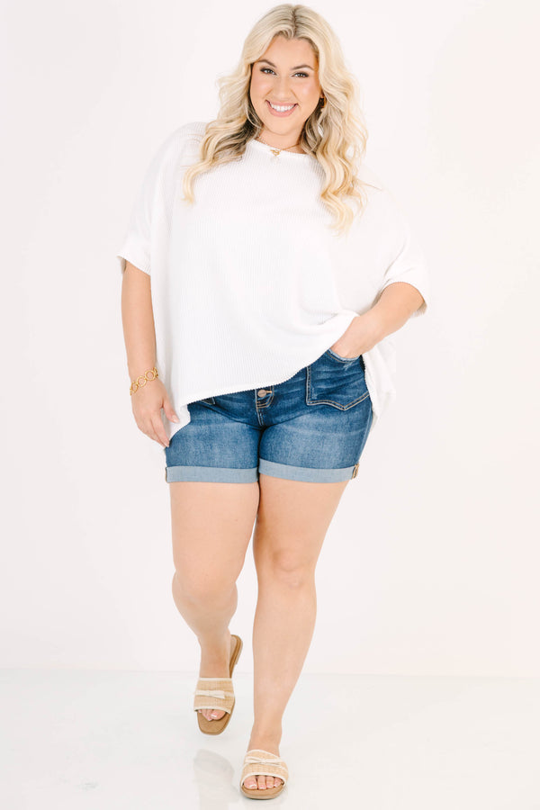 Plus Size dark wash denim shorts with a button-up fly, cuffed hems, and front seam detailing.