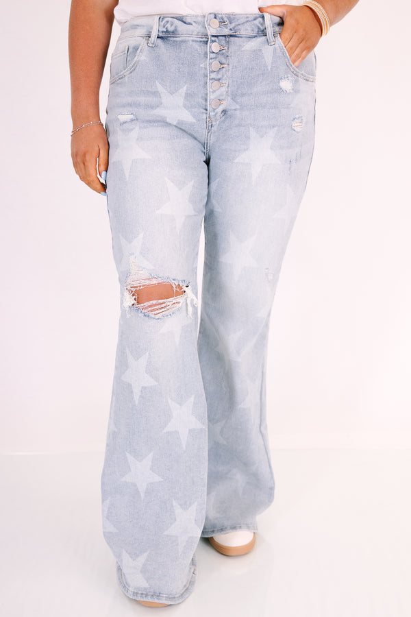 Plus Size light wash flare jeans with a white star pattern, button fly, and distressed knee.