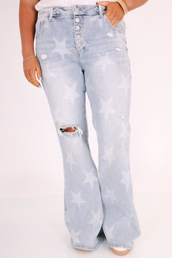 Plus Size light wash flare jeans with a white star pattern, button fly, and distressed knee.