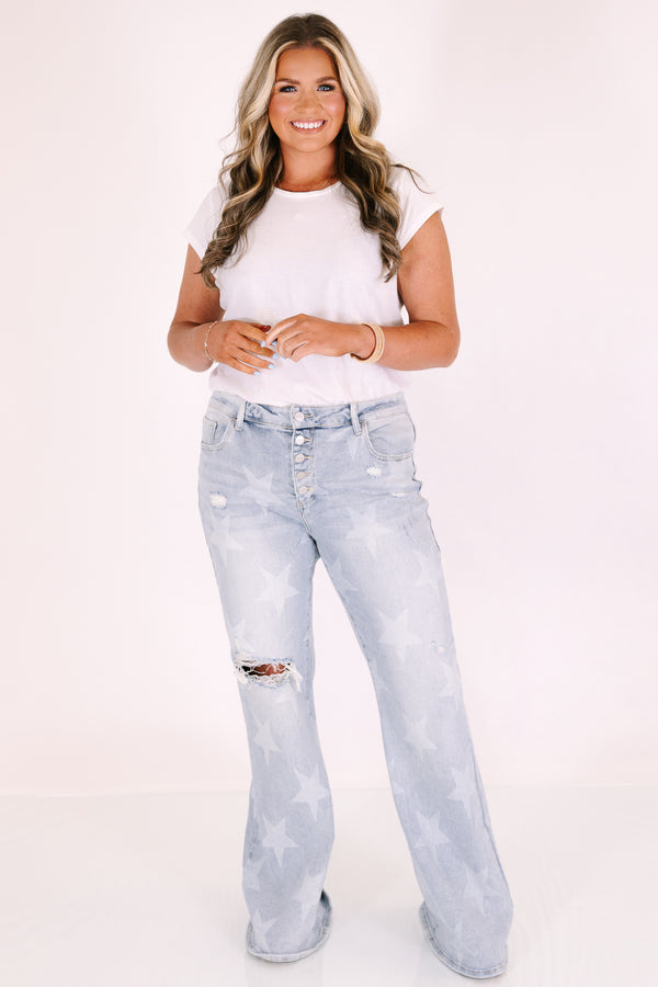 Plus Size light wash flare jeans with a white star pattern, button fly, and distressed knee.