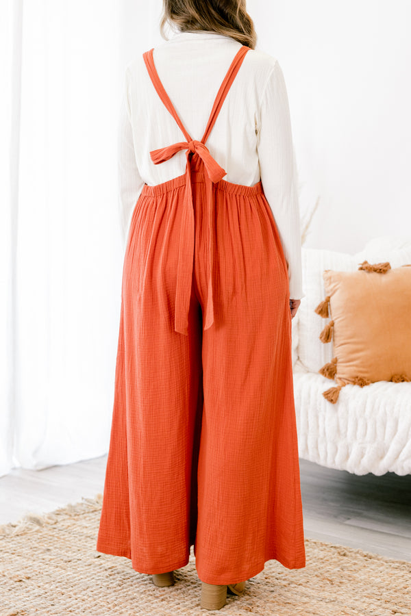 Chic Soul plus size clothing, rust colored sleeveless jumpsuit with two front pockets and a pocket on the chest that has fringe details 