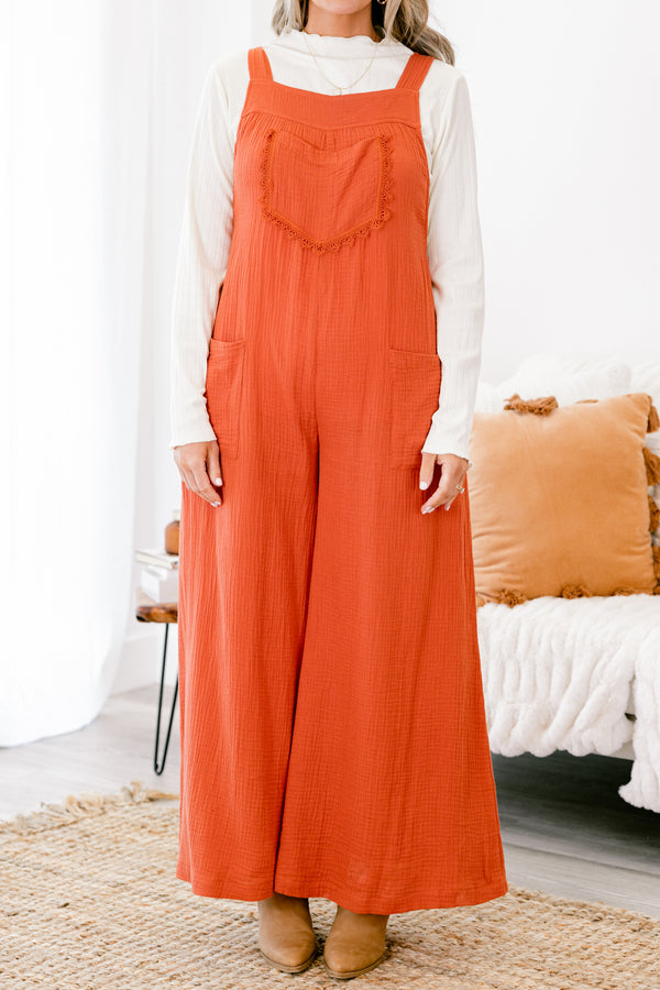 Chic Soul plus size clothing, rust colored sleeveless jumpsuit with two front pockets and a pocket on the chest that has fringe details 