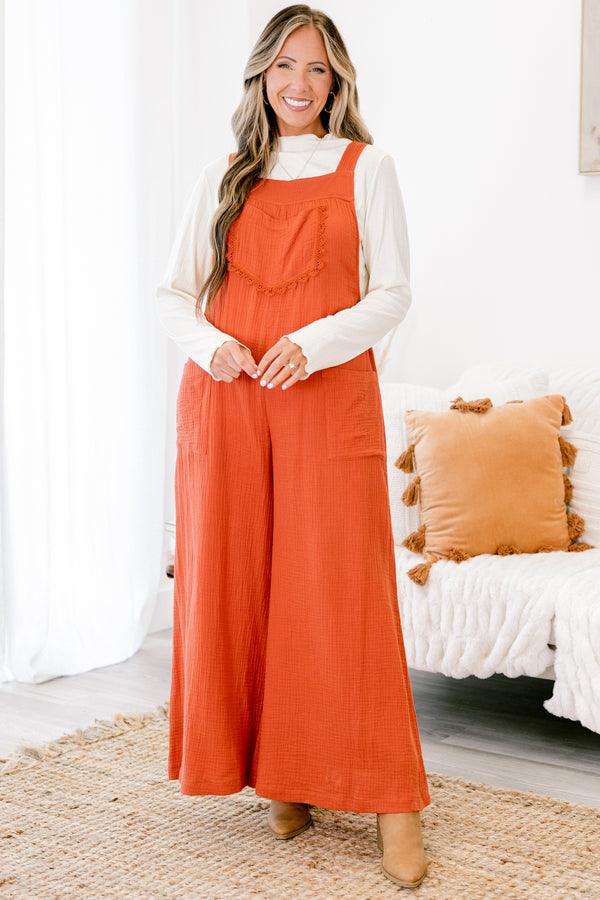 Chic Soul plus size clothing, rust colored sleeveless jumpsuit with two front pockets and a pocket on the chest that has fringe details 