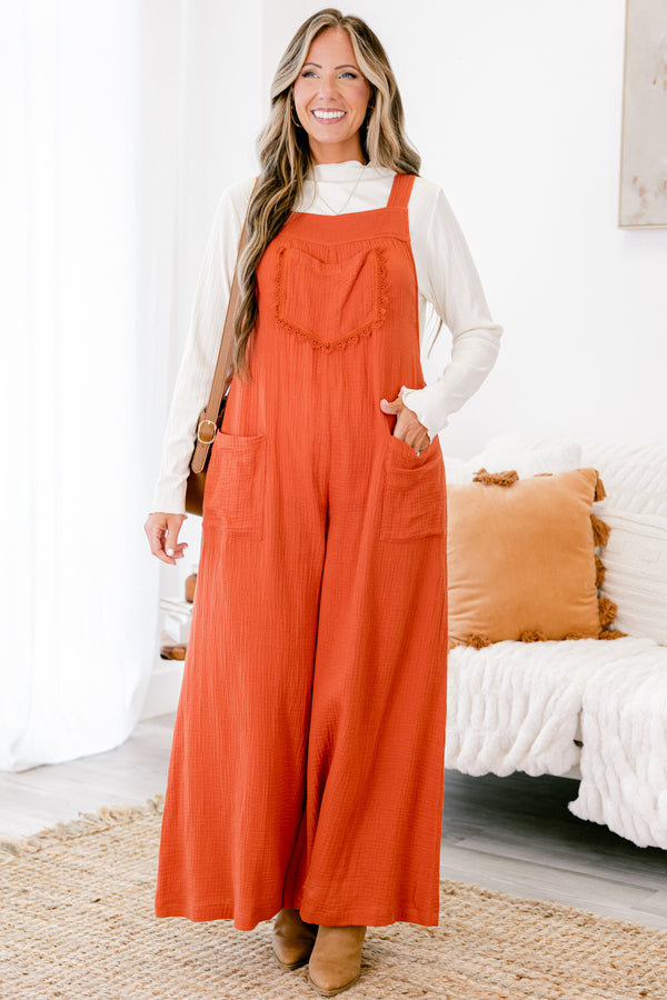 Chic Soul plus size clothing, rust colored sleeveless jumpsuit with two front pockets and a pocket on the chest that has fringe details 