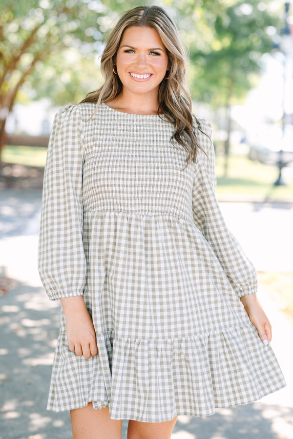 Plus Size green gingham dress with a smocked bodice, long puff sleeves, and a tiered skirt.
