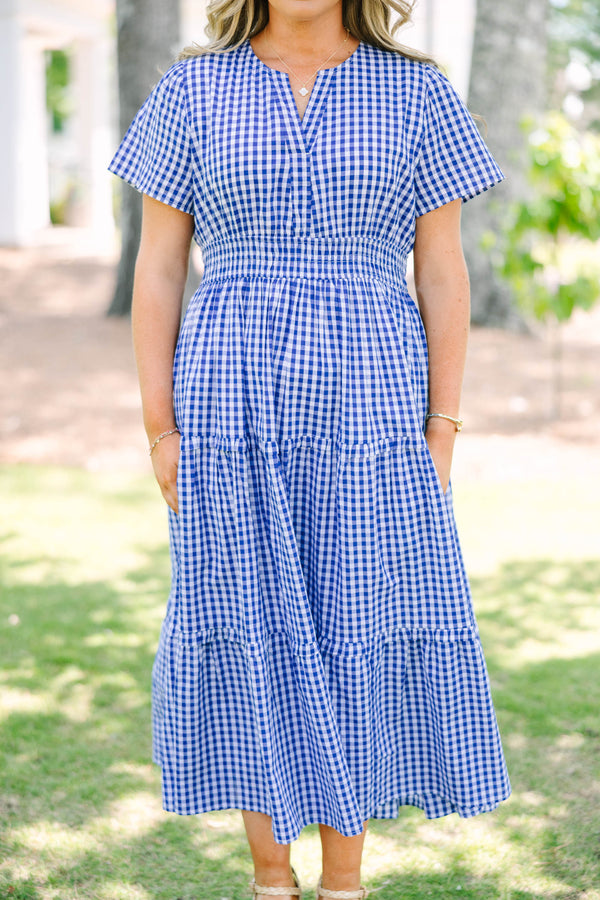 Plus size navy blue gingham midi dress with a smocked waist, V-neckline, and tiered flowy skirt.
