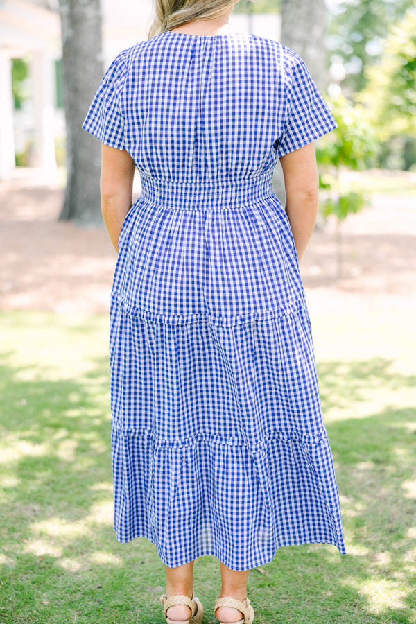 Plus size navy blue gingham midi dress with a smocked waist, V-neckline, and tiered flowy skirt.
