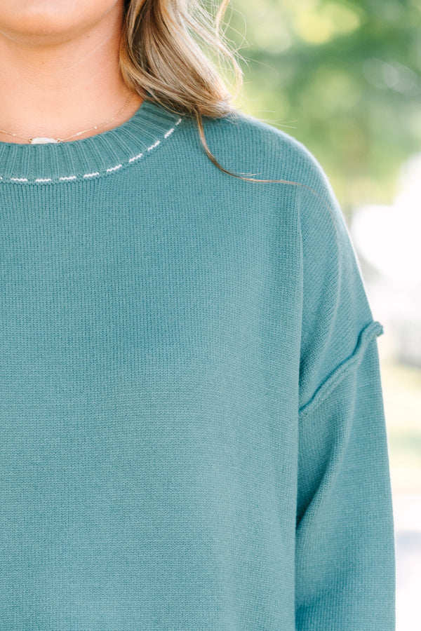 Plus Size green knit crewneck sweater with white contrast stitching on the neckline and ribbed hem.