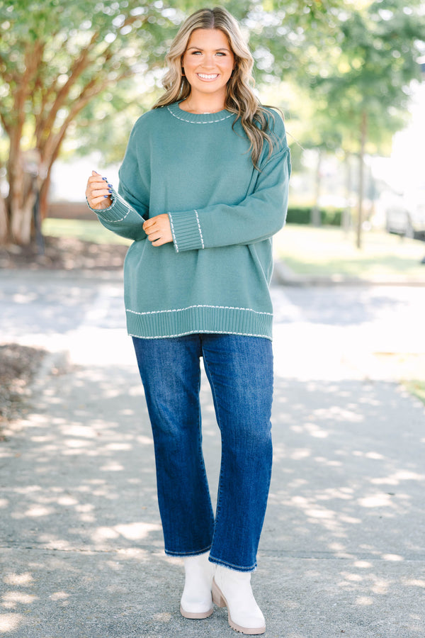Plus Size green knit crewneck sweater with white contrast stitching on the neckline and ribbed hem.