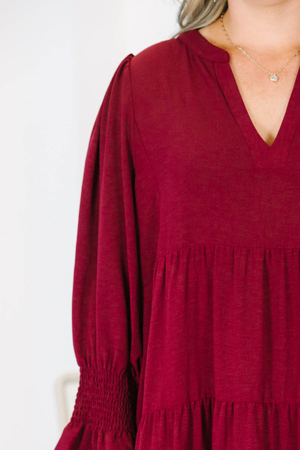 Plus Size burgundy tiered midi dress with a V-neckline and flutter sleeves in a textured fabric.