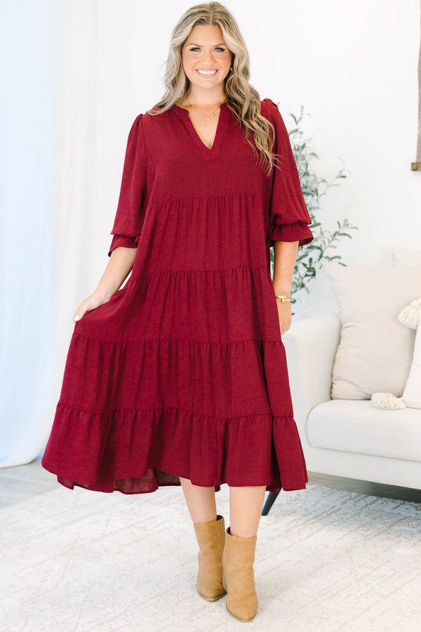 Plus Size burgundy tiered midi dress with a V-neckline and flutter sleeves in a textured fabric.