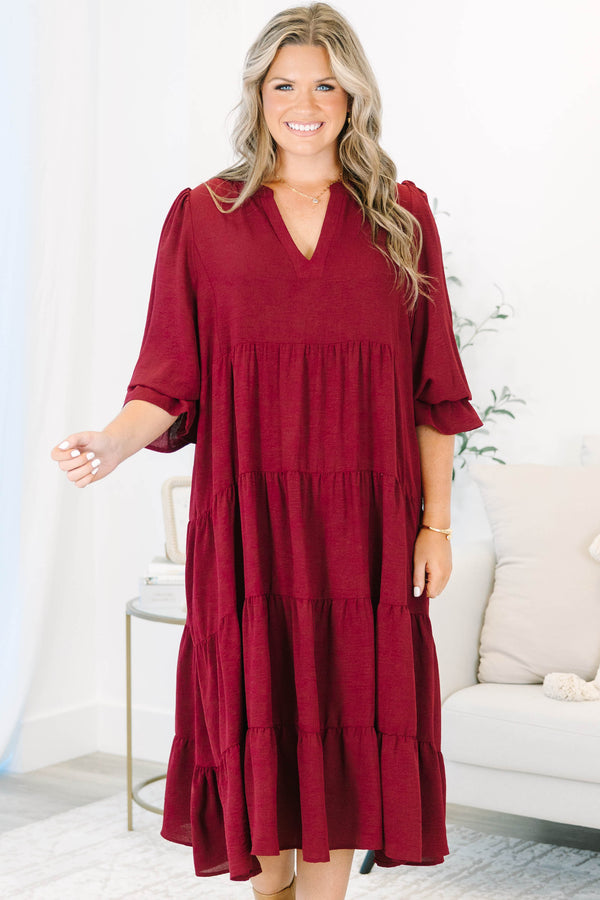 Plus Size burgundy tiered midi dress with a V-neckline and flutter sleeves in a textured fabric.