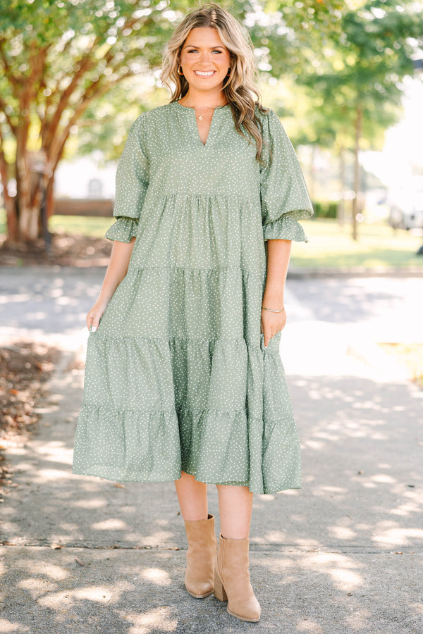 Plus Size green polka dot tiered midi dress with a v-neckline and three-quarter length sleeves.