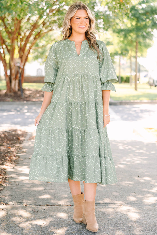 Plus Size green polka dot tiered midi dress with a v-neckline and three-quarter length sleeves.
