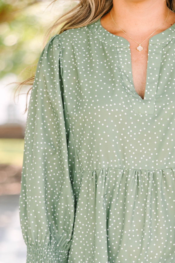 Plus Size green polka dot tiered midi dress with a v-neckline and three-quarter length sleeves.