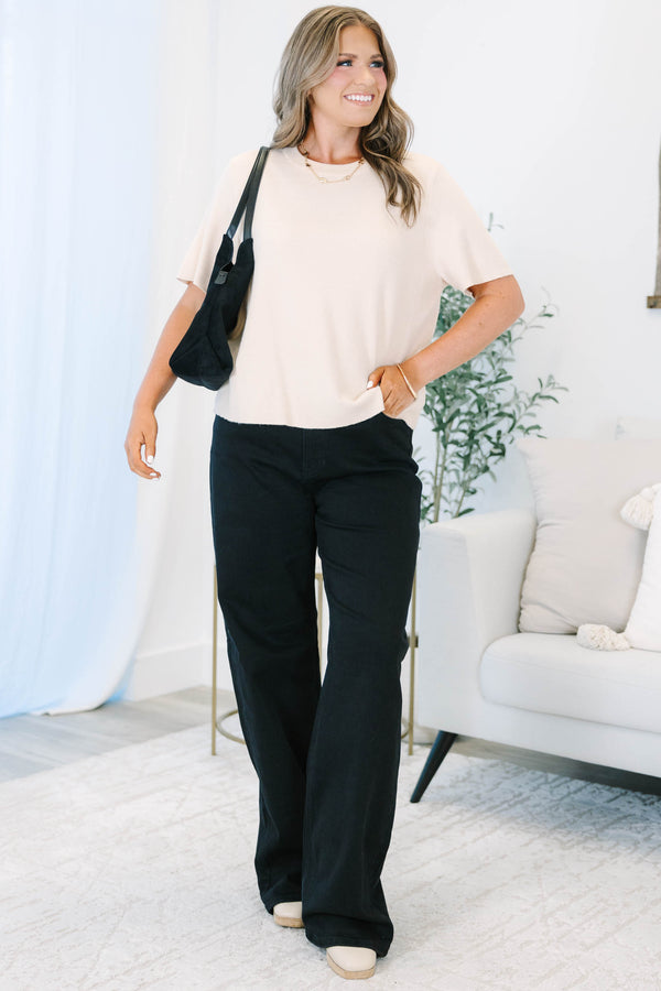 Plus size black wide leg jeans in a stretchy, high-waisted fit for a confident, feminine look.