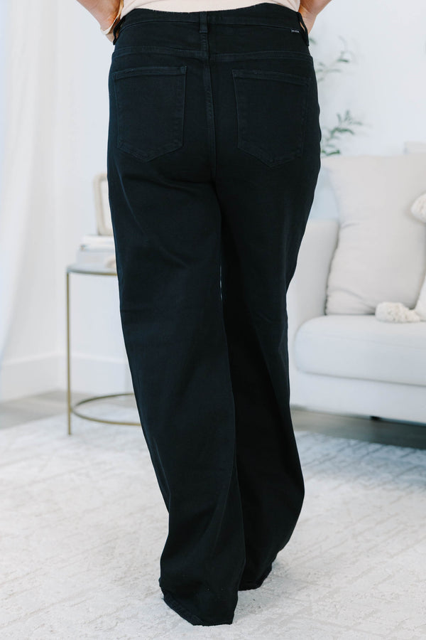 Plus size black wide leg jeans in a stretchy, high-waisted fit for a confident, feminine look.